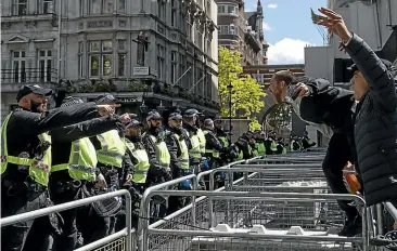  ?? GETTY IMAGES ?? Activists confront police officers on Whitehall as farRight linked groups gather around London’s statues on Saturday. Following a social media post by the farRight activist known as Tommy Robinson, members of farRight linked groups gathered around statues in London. Several statues in the UK have been targeted by Black Lives Matter protesters for their links to racism and the slave trade.