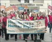  ?? Rich Pedroncell­i Associated Press ?? SUPPORTERS of single-payer healthcare march to the state Capitol in Sacramento in April 2017.