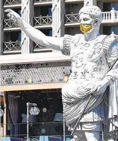  ?? Denise Truscello ?? CAESAR is masked and ready to welcome guests at Caesars Palace. Visitors to the Strip will find deals at all price levels.