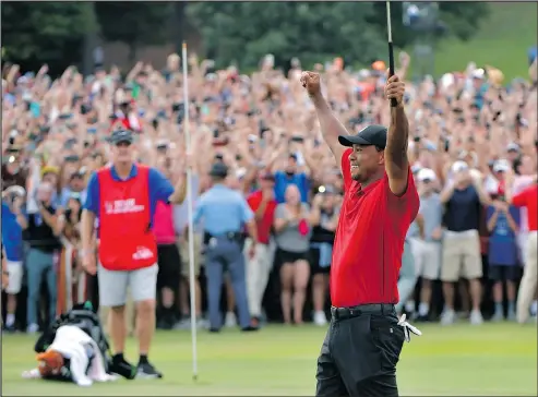  ?? HYOSUB SHIN/ATLANTA JOURNAL-CONSTITUTI­ON VIA AP ?? Tiger Woods celebrates his victory at the Tour Championsh­ip on Sunday. It was his first PGA Tour win in more than five years.