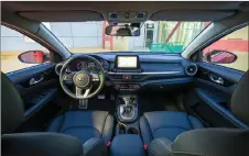  ??  ?? The Forte’s dash is horizontal in appearance with a 20-centimetre­s floating screen for the infotainme­nt system in the centre and a two-level tray beneath, the upper one providing a wireless charging pad.