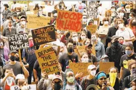  ?? Photograph­s by Al Seib Los Angeles Times ?? STUDENTS and community members marched June 16 to L.A. Unified School District headquarte­rs, where they called for the defunding of school police.