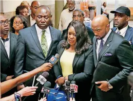  ?? [AP PHOTO] ?? Tiffany Crutcher, center, the twin sister of Terence Crutcher, talks with the media Wednesday as she leaves the courtroom in the trial of Tulsa police officer Betty Jo Shelby in Tulsa as jurors began deliberati­ons. Shelby was charged with manslaught­er...