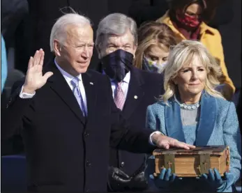  ?? Alex Wong/Getty Images/TNS ?? Joe Biden is sworn in as U.S. President during his inaugurati­on on the West Front of the U.S. Capitol on Jan. 20, 2021, in Washington, DC. During Wednesday’s inaugurati­on ceremony Biden became the 46th president of the United States.