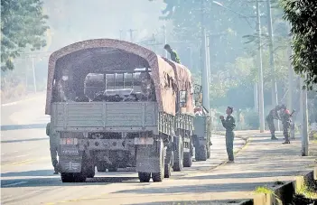  ?? – AFP photos ?? Soldiers keep watch along a blockaded road near Myanmar’s Parliament in Naypyidaw.