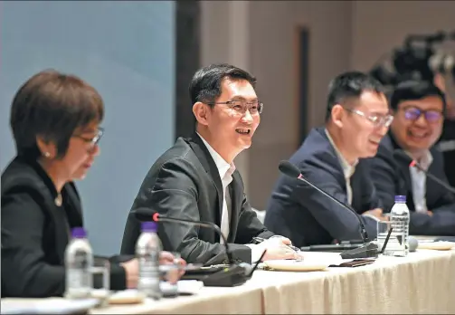  ?? TANG MINGMING / FOR CHINA DAILY ?? Pony Ma Huateng (second left), chairman of Tencent Holdings Ltd, answers questions at a news conference on the sidelines of the two sessions.