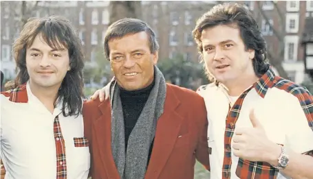  ?? Picture: Shuttersto­ck. ?? DJ Tony Blackburn with Les McKeown, right, and Ian Mitchell of the Bay City Rollers.