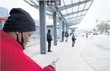  ?? E. JASON WAMBSGANS/CHICAGO TRIBUNE PHOTOS ?? Alexis Brown waits for a bus at the CTA 95th/Dan Ryan Station on Thursday. Brown, a lifelong resident of the South Side, said she used to drive but “it got too expensive.”