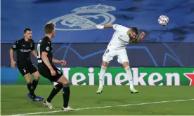  ?? Photograph: Gonzalo Arroyo/Uefa/Getty ?? Karim Benzema heads in his and Madrid’s second goal as they eased past Borussia Mönchengla­dbach to end up topping Group B.