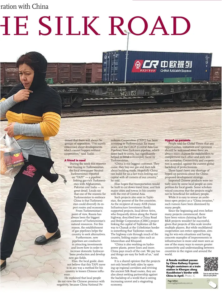  ?? Photo: IC ?? A female resident passes by China Railway Express freight containers at a train station in Khorgos along Kazakhstan’s border with China in April.