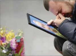  ?? EFREM LUKATSKY — THE ASSOCIATED PRESS FILE ?? The partner of Julia Sologub, a member of the flight crew of the Ukrainian 737-800 plane that crashed on the outskirts of Tehran, reacts as he holds a portrait of her at a memorial inside Borispil Internatio­nal Airport outside Kyiv, Ukraine, on Jan. 10, 2020.