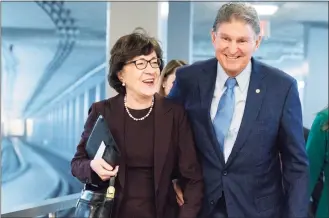  ?? Jacquelyn Martin / Associated Press ?? Sen. Joe Manchin, D-W.Va., a key vote on President Joe Biden’s domestic spending agenda, right, walks with Sen. Susan Collins, R-Maine, along the Senate Subway on Thursday on Capitol Hill in Washington.