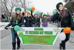  ?? FREDERIC HORE, GAZETTE FILES ?? Hudson’s annual Santa parade and St. Patrick’s Day parade draw enthusiast­ic crowds to the town’s main street. In the photo above (left), a young spectator is handed a candy cane during the 2002 Santa parade while the image beside it shows staff and...