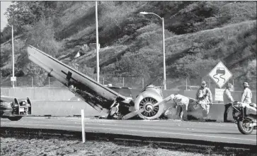  ?? Carolyn Cole Los Angeles Times ?? A WORLD War II-era aircraft crash-landed on the 101 Freeway in Agoura Hills, closing the highway for hours Tuesday. The pilot survived. The plane belonged to a nonprofit formed to preserve World War II history.