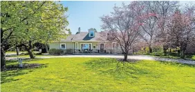  ?? ?? The home has more than 3,000 square feet of living space. The main floor features an open-concept dining and living room with a wood-burning fireplace and a modern kitchen with quartz countertop­s, a walk-in pantry and a powder room.