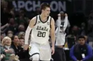  ?? KIICHIRO SATO — THE ASSOCIATED PRESS ?? Michigan State’s Matt McQuaid (20) celebrates after a 3-pointer during the Big Ten Conference championsh­ip game March 17 in Chicago.