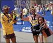  ?? MATT STONE — BOSTON HERALD ?? Winners Sisay Lemm and Hellen Obiri with her daughter Tania after winning the 128th Boston Marathon.