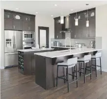  ??  ?? Even better than a good kitchen island is a kitchen with both an island and a peninsula, as with Excel Homes’ Kingston show home in Sunset Ridge, above, or the St. Andrews 3 show home by Stepper Homes, below.