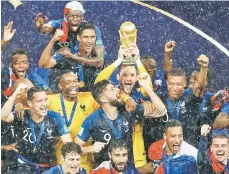  ??  ?? France’s Hugo Lloris lifts the trophy as they celebrate winning the World Cup final against Croatia in Russia. — AFP photo