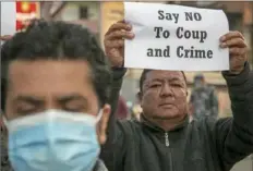  ?? Niranjan Shrestha/Associated Press ?? A small group of Nepalese Civil society activists hold placards reacting to the developmen­ts in Myanmar during a protest in Kathmandu, Nepal, on Monday.