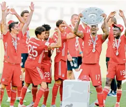  ?? — AFP ?? Bayern Munich players celebrate winning their eighth consecutiv­e German league title post their 4-0 win over Wolfsburg in Wolfsburg on Sunday.