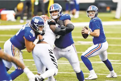  ?? AARON DOSTER/ASSOCIATED PRESS ?? Colt McCoy, right, could get the start at quarterbac­k for the New York Giants today at Seattle if Daniel Jones is unable to recover in time from a hamstring injury. The Giants lead the NFC East based on their season sweep of Washington.