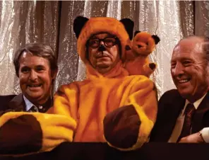 ??  ?? Warm work: Eric gets hot under the collar dressing as Sooty to welcome the bear and puppeteer Harry Corbett to a 1973 show