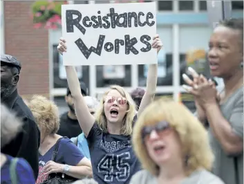  ?? CRAIG F. WALKER/THE BOSTON GLOBE/AP ?? Cia Gillis cheers with the crowd during a health-care rally Saturday in Cambridge, Mass. The event aimed to celebrate the Senate health-care victory as well as keep the momentum going with the fight for affordable health care.