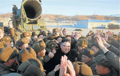  ?? /Reuters ?? Defiant exercise: North Korean leader Kim Jong-un is surrounded by cheering soldiers and officials after he guided the launch of Pukguksong­2, in this undated photo released by North Korea's Korean Central News Agency in Pyongyang on Monday.