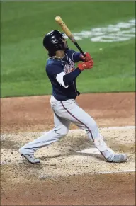  ?? Sarah Stier / Getty Images ?? Ozzie Albies of the Atlanta Braves hits a two-run home run during the fourth inning against the New York Mets at Citi Field on Friday in New York. The Braves won 15-2.