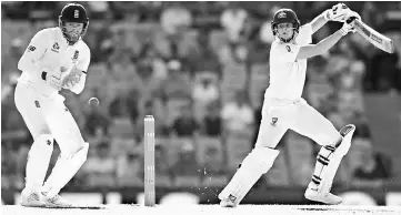  ??  ?? Steve Smith (right) cuts the ball past England’s wicketkeep­er Jonny Bairstow on the second day of the fifth Ashes cricket Test match at the SCG in Sydney. — AFP photo