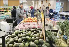  ?? ?? Shoppers pick out items at a grocery store in Glenview, Ill., on Nov. 19, 2022. The Commerce Department issues its second of three estimates of how the U.S. economy performed in the second quarter of 2022. (AP)