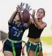  ?? Ashley Landis/Associated Press ?? Aly Young, 17, left, and Shale Harris, 15, reach to catch a pass as they try out for the Redondo Union High School girls flag football team in Redondo Beach, Calif.