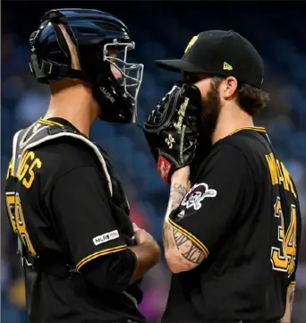  ?? Matt Freed/ Post- Gazette photos ?? Catcher Jacob Stallings talks with starting pitcher Trevor Williams about how to get out of a third- inning jam Wednesday night against the Milwaukee Brewers at PNC Park. The Pirates were swept by the Brewers in the three- game series.