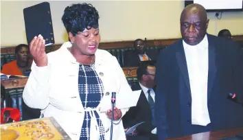  ?? — (Picture by John Manzongo) ?? Newly-elected Bikita West MP Cde Beauty Chabaya takes her oath under the watchful eyes of Clerk of Parliament Mr Kennedy Chokuda during her swearing in ceremony in Harare yesterday.