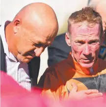  ?? Picture: AAP IMAGE ?? Trainer Stephen Lee speaks with jockey Jim Byrne after combining for a win at Doomben this season.