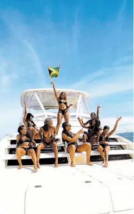  ?? ?? Adams and her girls bask in the island sun, making waves as Jamaican hotties on a yacht.