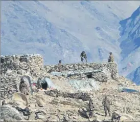  ??  ?? PLA soldiers dismantle structures set up by the Chinese army in Ladakh region.
