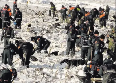  ??  ?? Russian Ministry for Emergency Situations Teams work Monday at the scene of a plane crash in Stepanovsk­oye village, about 25 miles from Russia’s Domodedovo Airport.