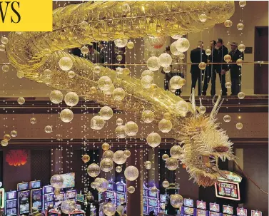  ?? ETHAN MILLER / GETTY IMAGES ?? A 1.25-ton glass dragon chandelier hangs as the centrepiec­e of Lucky Dragon Hotel & Casino in Las Vegas during its grand opening Dec. 3. The resort is designed to give visitors an authentic Asian cultural and gambling experience.