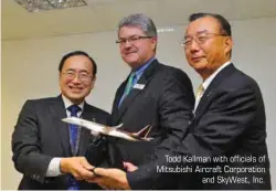  ??  ?? Todd Kallman with officials of Mitsubishi Aircraft Corporatio­n
and SkyWest, Inc.