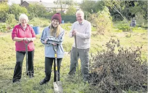  ??  ?? ●● Berni Burgon, chair of the South Park Allotment Associatio­n, Becky, a supervisor for the team and Mike Bull, committee member of the South Park Allotment Associatio­n at the site; inset, the land before the work