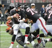  ?? BOB ANDRES / BANDRES@AJC.COM ?? Quarterbac­k Matt Ryan is sacked by the Bengals in the fourth quarter, which forced the Falcons to settle for a field goal. The 37-36 loss drops the Falcons to 1-3 and last place in the NFC South.