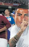  ??  ?? Fans wear masks of Ronaldo, left, and Lionel Messi during the World Cup.