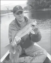  ?? Simonson ?? The author picks up a 24-inch spring walleye behind a small breakline on the Sheyenne River in southeaste­rn North Dakota.
Photos