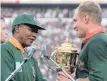  ?? ROSS SETFORD AP Photo ?? On June 24, 1995, South African rugby captain Francois Pienaar receives the Rugby World Cup from Nelson Mandela. |