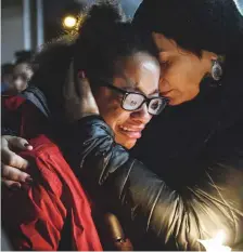  ?? AP ?? Isabel Kinnane Smith of Allderdice is comforted by Lesley Britton, at the vigil held blocks away from where Robert Bowers shot dead 11 people.