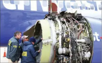  ?? NTSB VIA AP ?? National Transporta­tion Safety Board investigat­ors examine damage to the engine of the Southwest Airlines plane that made an emergency landing at Philadelph­ia Internatio­nal Airport in Philadelph­ia on Tuesday, April 17, 2018.