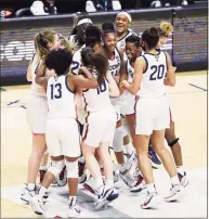  ?? Jessica Hill / Associated Press ?? The UConn women’s basketball team celebrates its win over Marquette in the Big East Tournament championsh­ip on Monday at Mohegan Sun Arena in Uncasville.