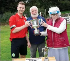  ??  ?? Greystones captain Sean Minogue receives the cup from Sydney Byrne O’Reilly and WDFL’s Liam Kilbride.